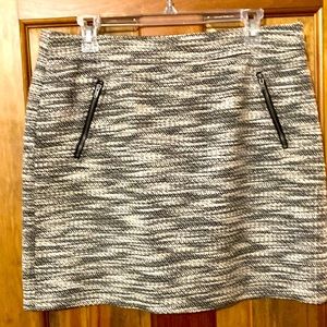 A line skirt in black and cream tweed fabric fully lined with cute zipper detail